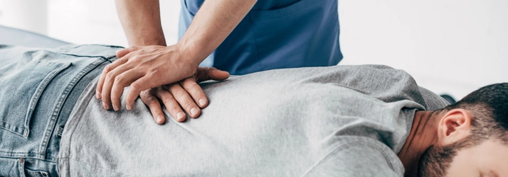 Chiropractor performing a back adjustment.