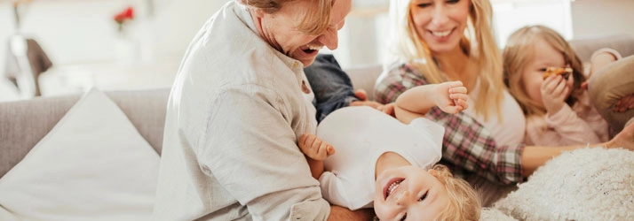 Happy family on a couch.