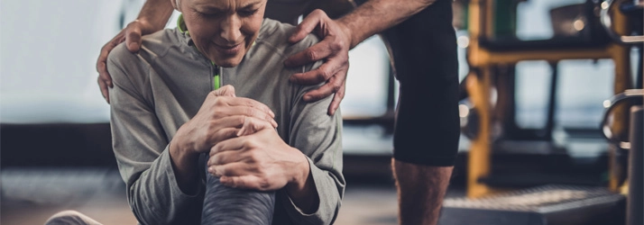 Chiropractic Gilbert AZ Knee Pain Lady A person holding their knee in pain.