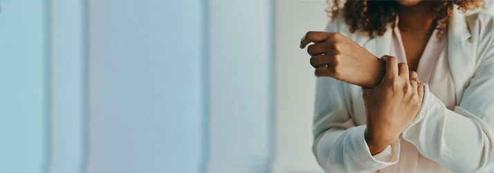 A person holding their wrist.