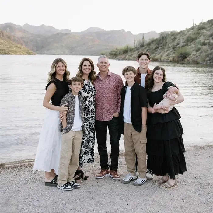 Chiropractor Gilbert AZ David Campbell With Family HP Circle 1 Dr. David Campbell standing besides a lake with his family with mountains in the background.
